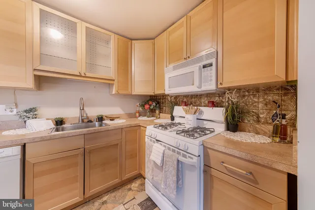 a kitchen with a sink stove and refrigerator