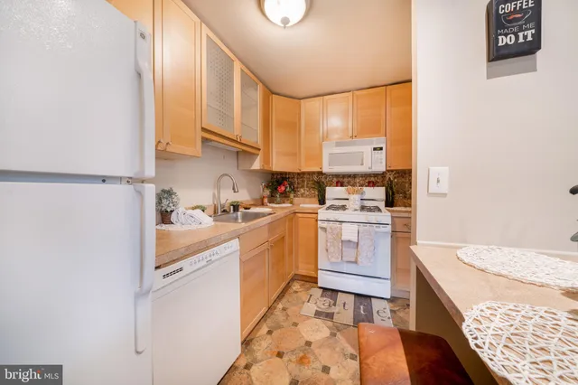 a view of a hallway with cabinets