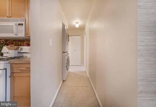 a view of a hallway with washer and dryer