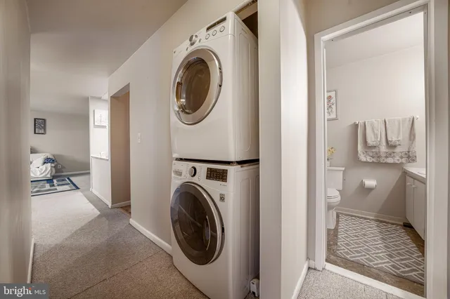 a white toilet sitting next to a bathroom sink and tub