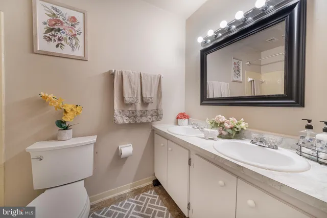 a bathroom with a sink vanity and a mirror