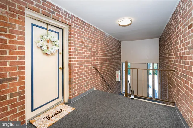 a view of a hallway with paintings on the wall