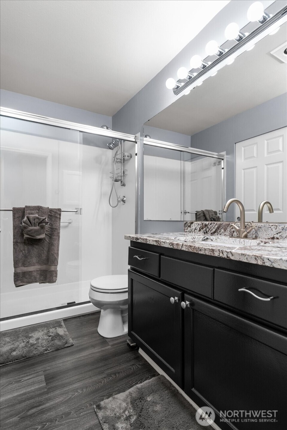 723 114th Street Southwest, Unit Y203 Everett, WA 98204 - Photo 21 of 35 a bathroom with a granite countertop sink a toilet and a shower