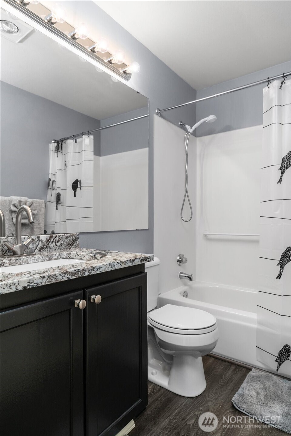 723 114th Street Southwest, Unit Y203 Everett, WA 98204 - Photo 24 of 35 a bathroom with a granite countertop toilet sink and mirror