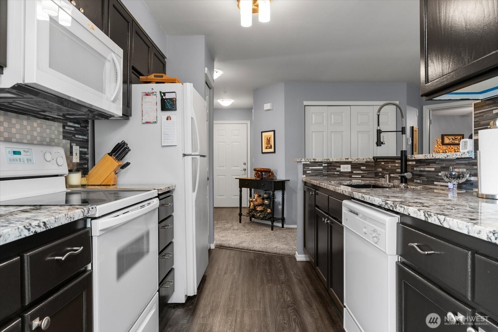 723 114th Street Southwest, Unit Y203 Everett, WA 98204 - Photo 10 of 35 a kitchen with stainless steel appliances granite countertop a stove a sink and a refrigerator