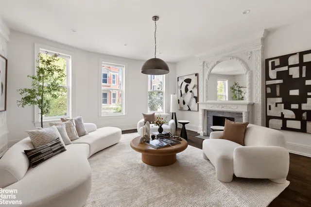 a living room with fireplace furniture and a wooden floor