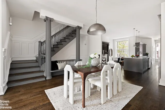 a living room with furniture a chandelier and a fireplace