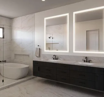 a bathroom with a double vanity sink mirror and bathtub