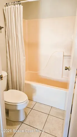 a bathroom with a toilet and a bathtub