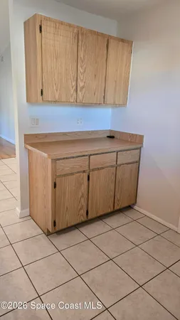 a view of a kitchen with white cabinets
