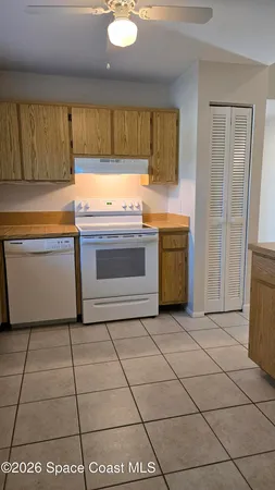 a kitchen with a stove top oven cabinets and a refrigerator