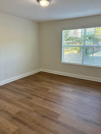 a bedroom with a bed couch and window