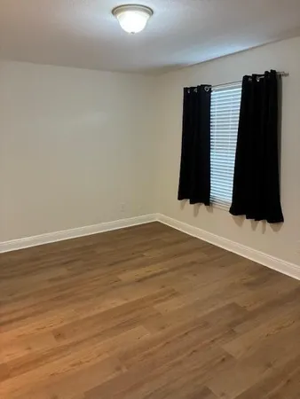 a view of walk in closet with clothes
