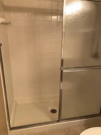 a bathroom with a glass shower door