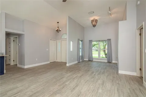 a view of a room with wooden floor and mirror