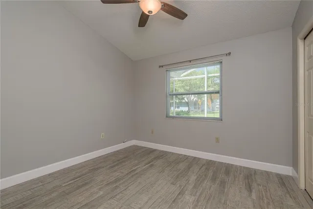 a sign board with buildings in the background