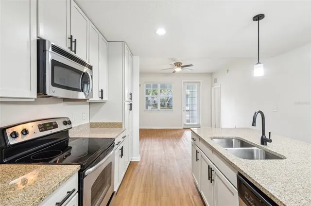 a kitchen that has a sink and a stove top oven