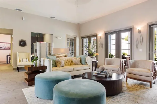 a living room with furniture and large windows