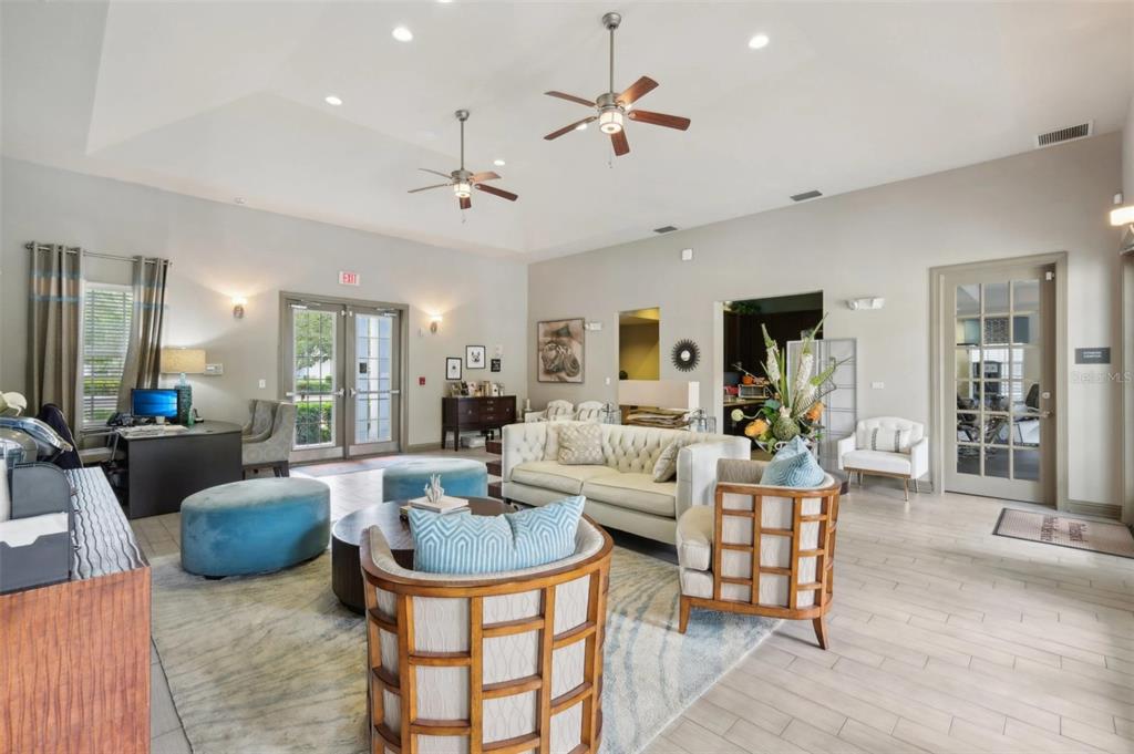 3334 South Bismark Lane, Unit 1B01304 Jupiter, FL 33458 - Photo 27 of 36 a living room with furniture a chandelier and a dining table