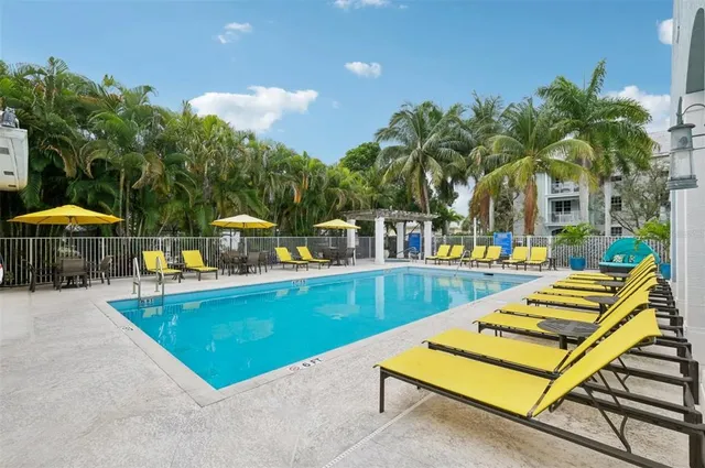 a view of swimming pool with chairs and tables