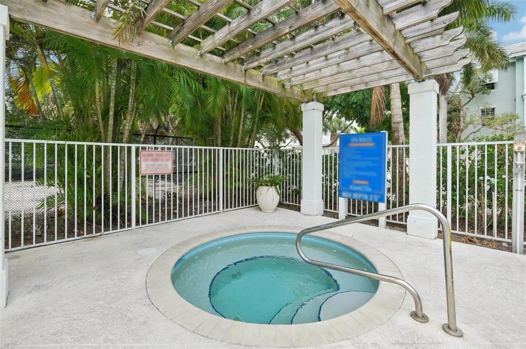 3334 South Bismark Lane, Unit 1B01304 Jupiter, FL 33458 - Photo 35 of 36 a view of a swimming pool with a porch and furniture