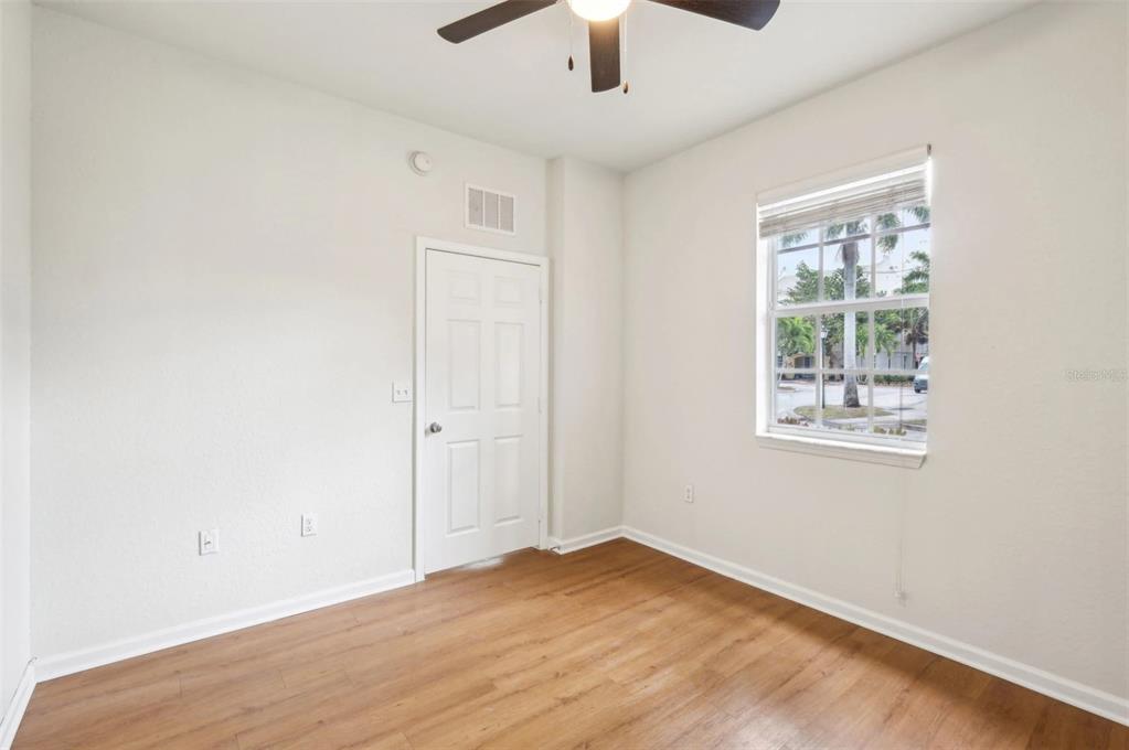 3334 South Bismark Lane, Unit 1B01304 Jupiter, FL 33458 - Photo 10 of 36 an empty room with a window and a ceiling fan