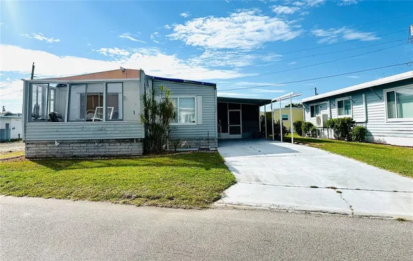 a view of house with outdoor space and parking