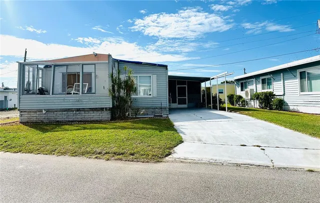 a view of house with outdoor space and parking