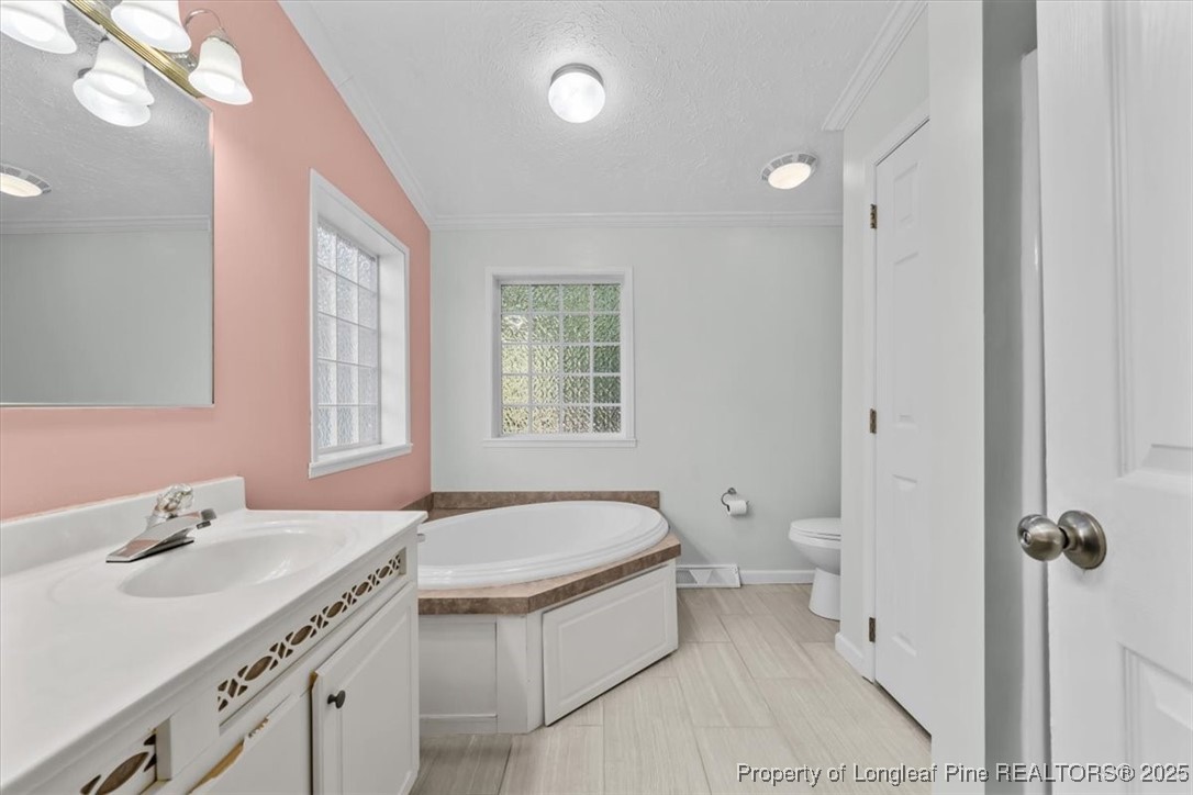 11891 Aberdeen Road Aberdeen, NC 28315 - Photo 13 of 35 a spacious bathroom with a granite countertop sink a toilet and a mirror