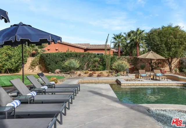 a view of house with outdoor space and swimming pool