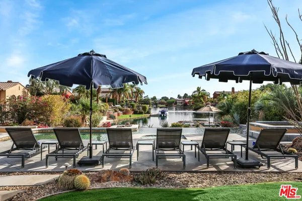 a view of chairs and table under an umbrella