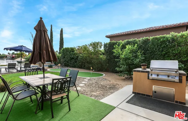 a patio with a table and chairs