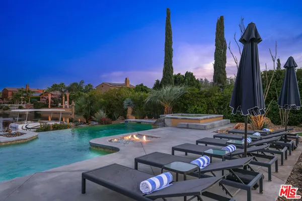 a view of a backyard with couches table and chairs