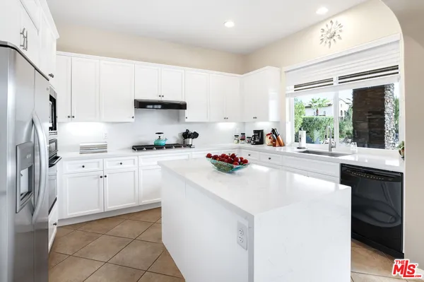a kitchen with appliances cabinets and a sink