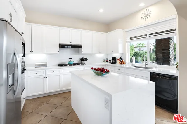 a kitchen with appliances cabinets and a sink