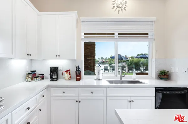 a kitchen with a sink and large window