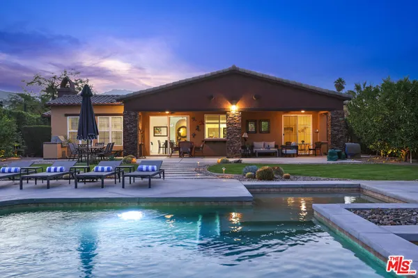a swimming pool with outdoor seating and yard