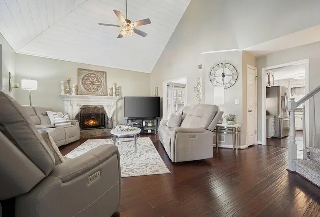 a living room with furniture a large window and a flat screen tv