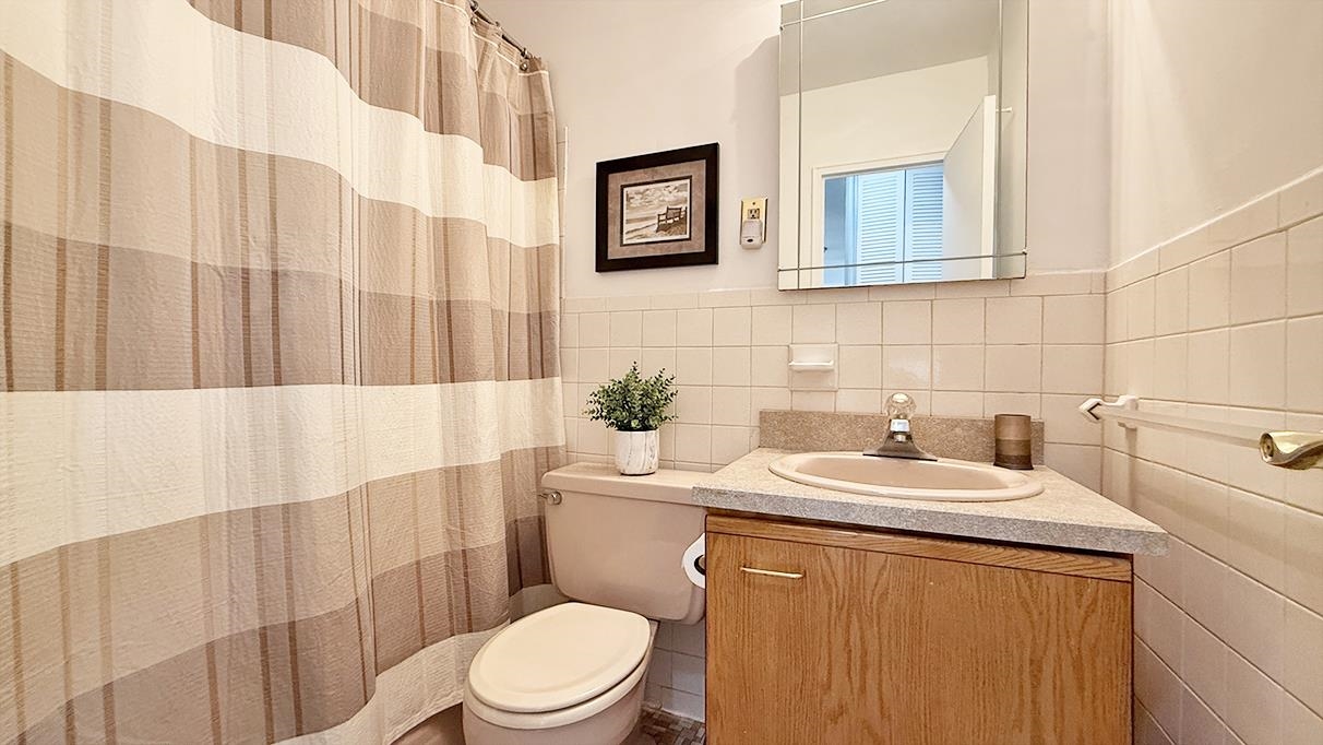 380 Mountain Road, Unit 714 Union City, NJ 07087 - Photo 14 of 31 a bathroom with a sink a toilet and shower curtain
