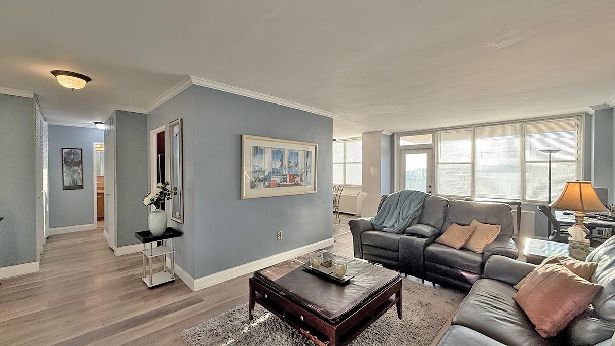 380 Mountain Road, Unit 714 Union City, NJ 07087 - Photo 3 of 31 a living room with furniture and wooden floor