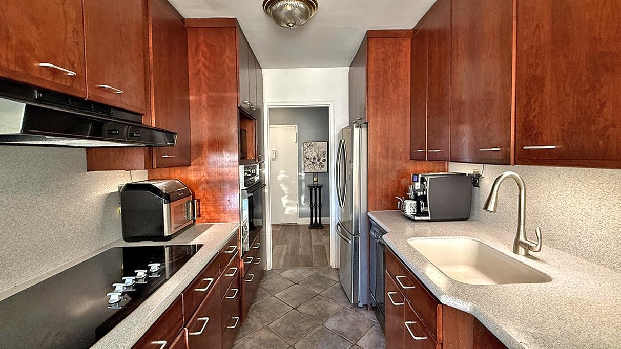 380 Mountain Road, Unit 714 Union City, NJ 07087 - Photo 6 of 31 a kitchen with a sink stove and cabinets