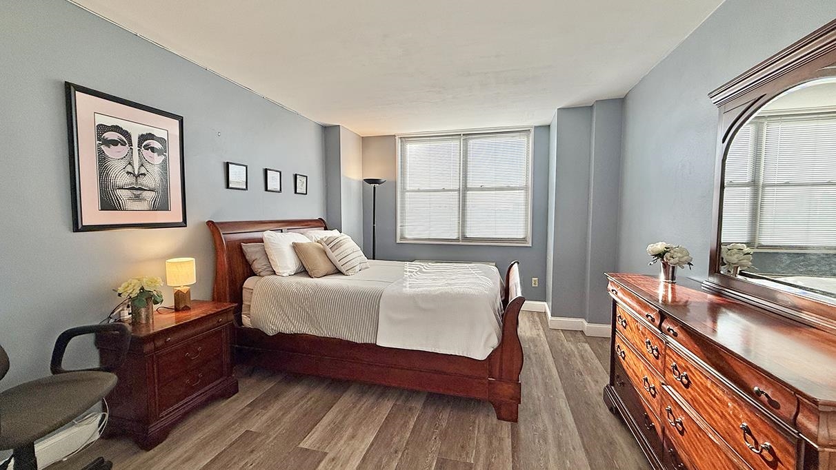 380 Mountain Road, Unit 714 Union City, NJ 07087 - Photo 9 of 31 a spacious bedroom with a bed and wooden floor