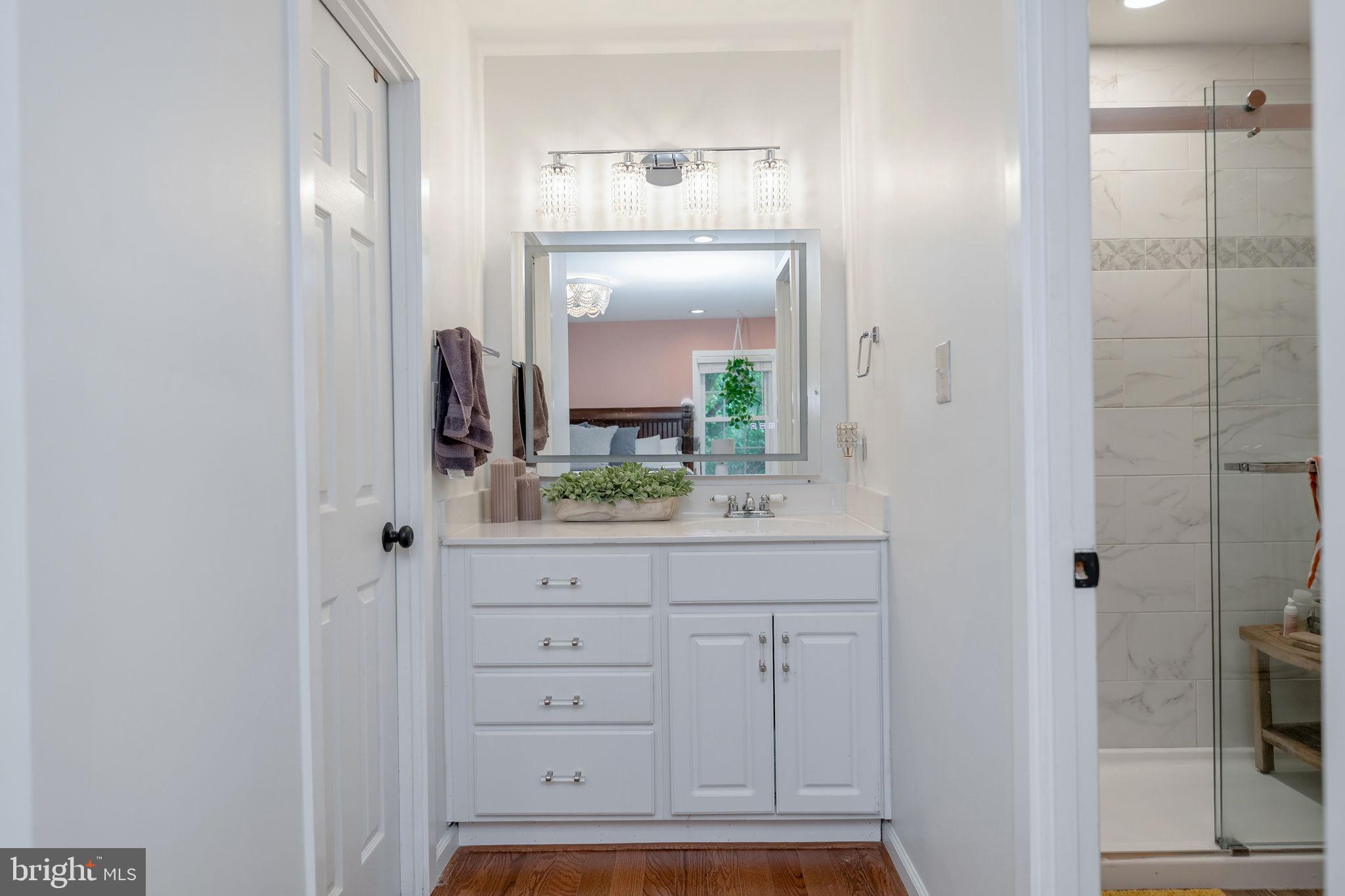 7603 Modisto Lane Springfield, VA 22153 - Photo 25 of 57 a bathroom with a sink and a mirror