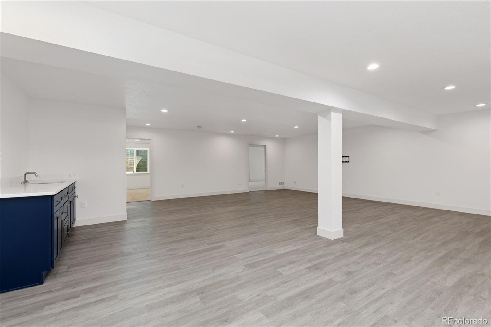 5540 Juniper Drive Brighton, CO 80601 - Photo 27 of 41 a view of an empty room with wooden floor