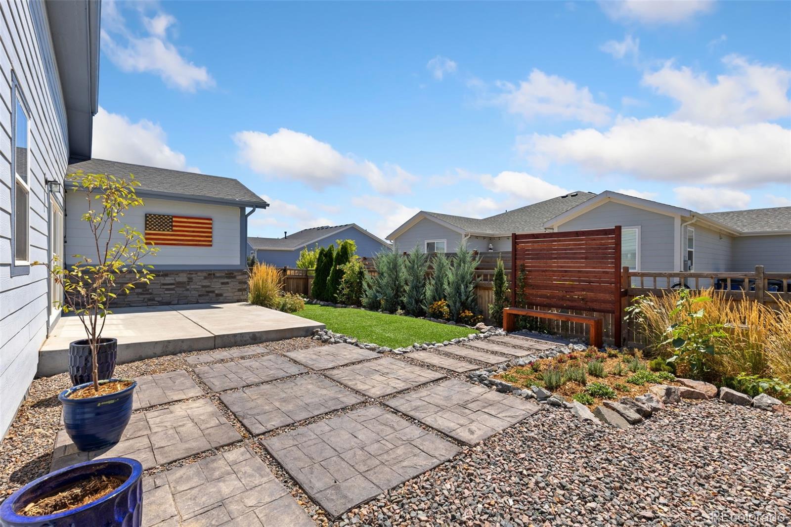 5540 Juniper Drive Brighton, CO 80601 - Photo 34 of 41 a view of a backyard with plants and a patio