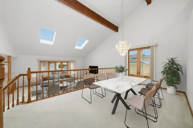 a view of a dining room with furniture and a window