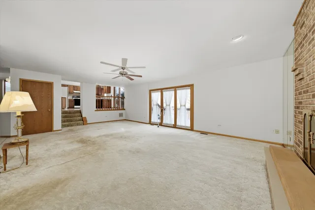 a view of a livingroom with a ceiling fan and window