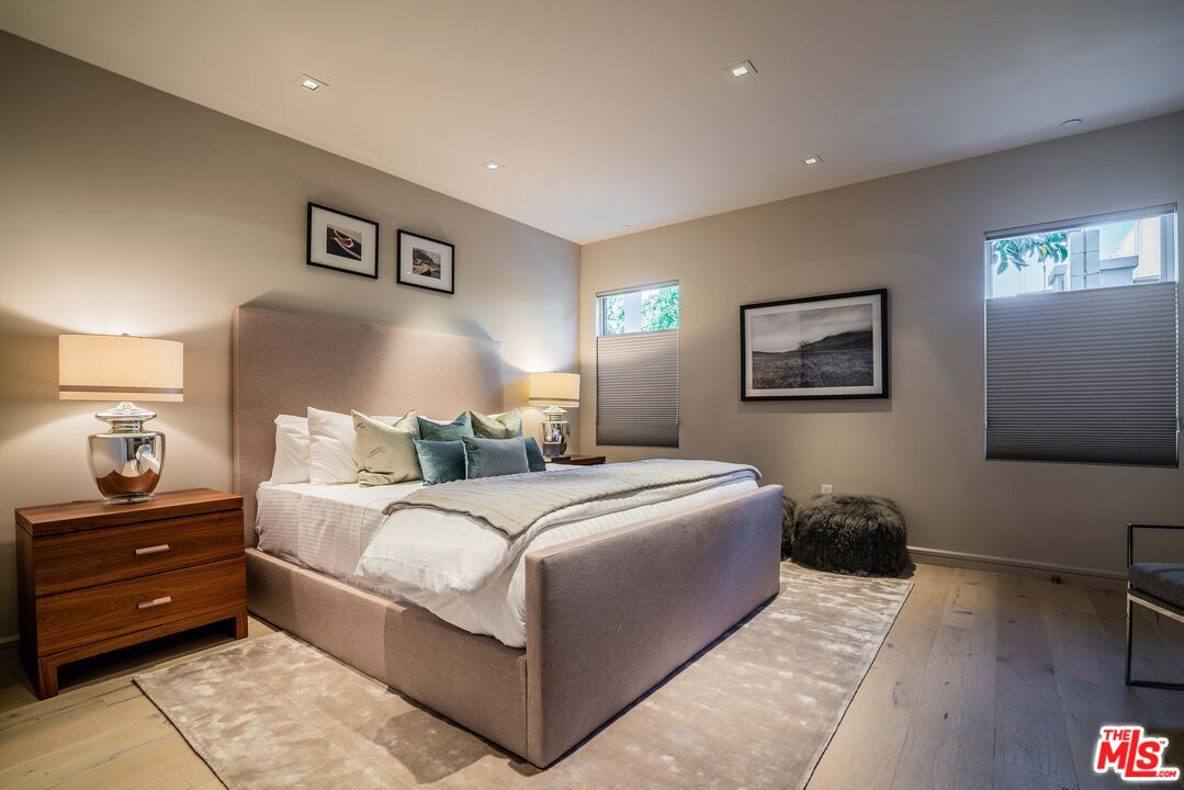 2391 Roscomare Road, Unit 401 Los Angeles, CA 90077 - Photo 6 of 22 a bedroom with a bed and a night stand
