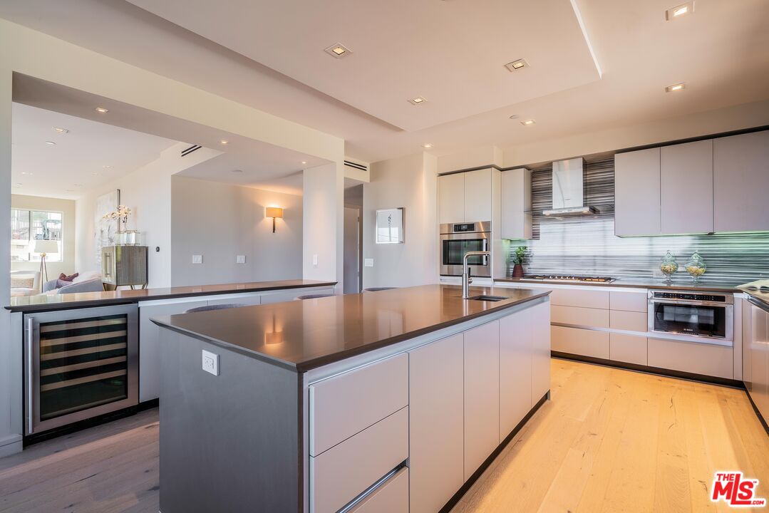 2391 Roscomare Road, Unit 401 Los Angeles, CA 90077 - Photo 10 of 22 a kitchen with stainless steel appliances granite countertop a sink and a stove