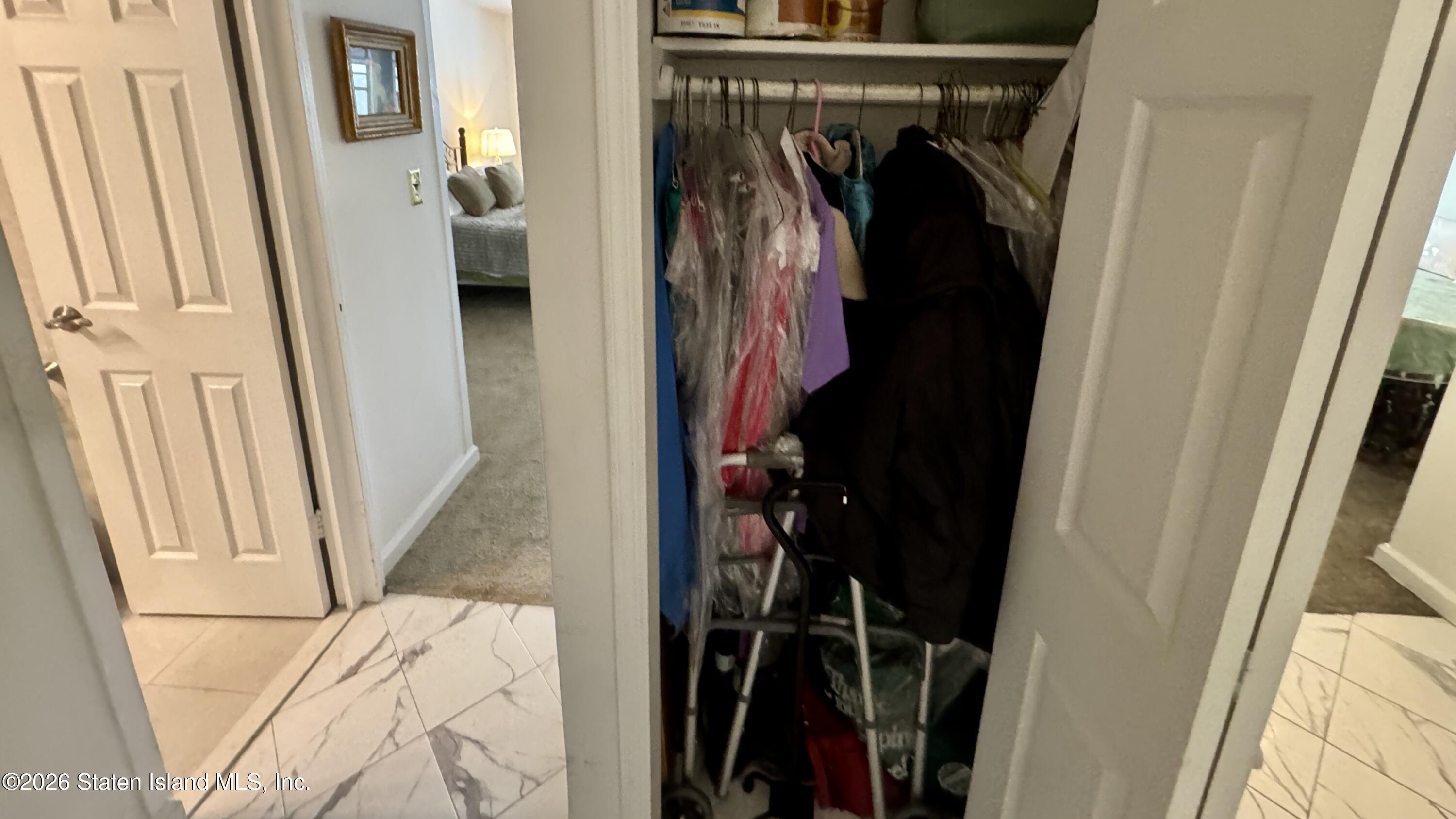 1100 Clove Road, Unit 2B Staten Island, NY 10301 - Photo 14 of 52 a view of walk in closet with clothes and shoes
